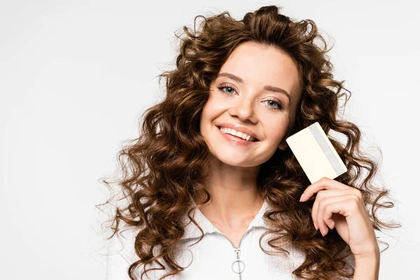 Beautiful cheerful girl holding credit card, isolated on white — Stock Photo