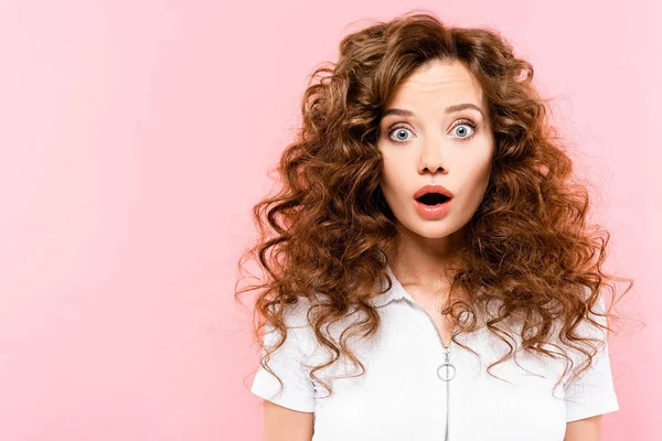 Beautiful surprised curly girl, isolated on pink — Stock Photo