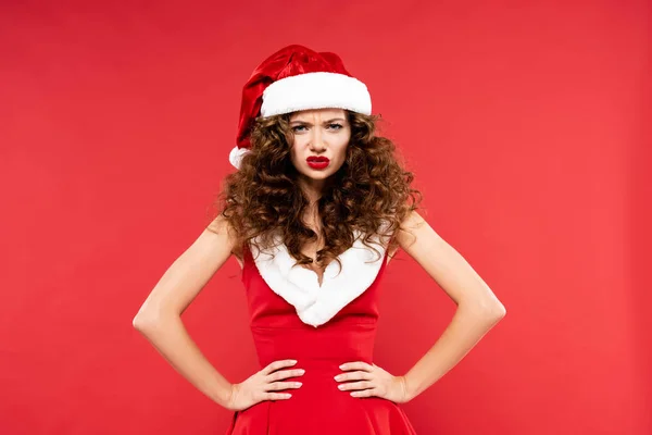 Angry beautiful girl posing in santa costume, isolated on red — Stock Photo