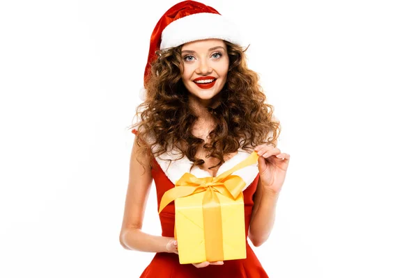 Beautiful smiling girl in santa costume holding christmas present, isolated on white — Stock Photo