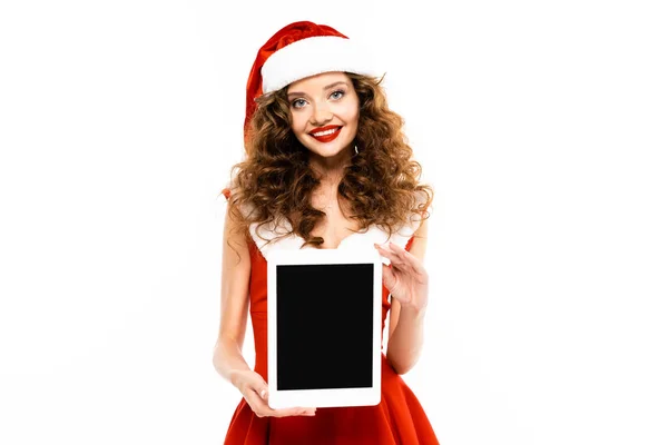 Веселая девушка в костюме Санты показывает цифровой планшет с чистым экраном, изолированный на белом — стоковое фото