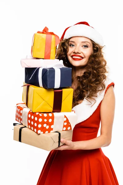 Happy girl in santa costume holding stack of gifts, isolated on white — Stock Photo