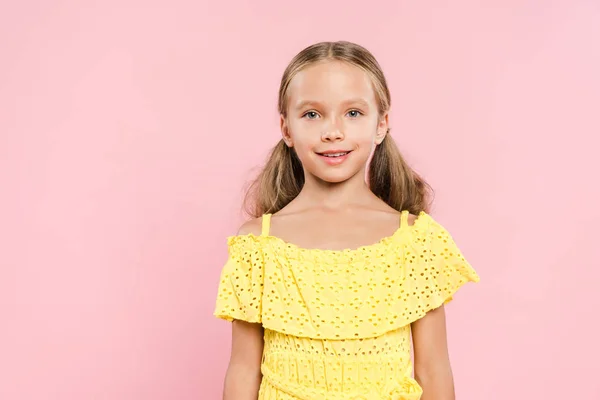 Smiling and cute kid looking at camera isolated on pink — Stock Photo