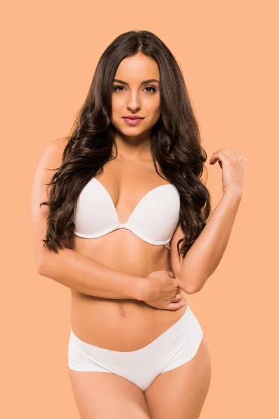 Sexy mulher de pé no branco lingerie isolado no bege — Stock Photo