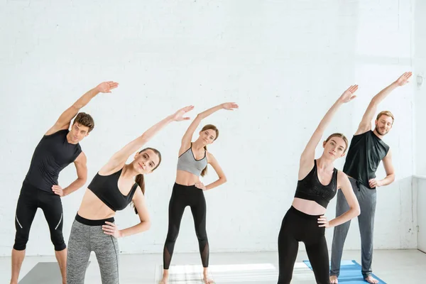 Fünf junge Leute in Star-Pose mit der Hand auf der Hüfte — Stockfoto