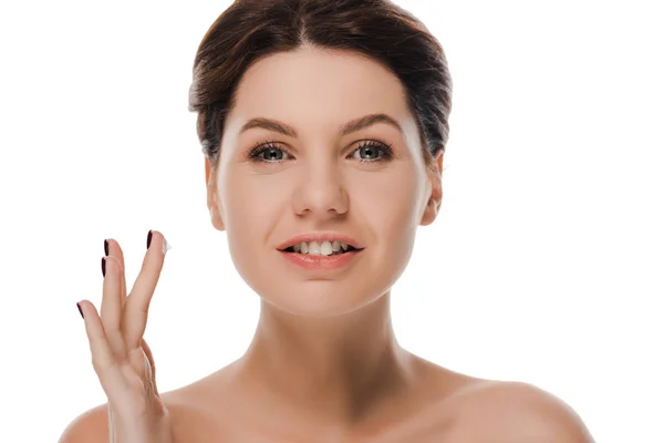 Happy naked woman with face cream on finger looking at camera isolated on white — Stock Photo