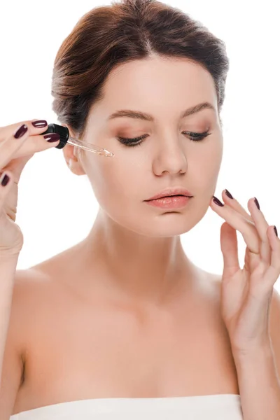 Attractive woman holding pipette while applying serum isolated on white — Stock Photo