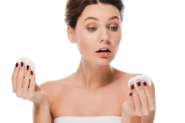 Surprised woman looking at cotton pad isolated on white — Stock Photo