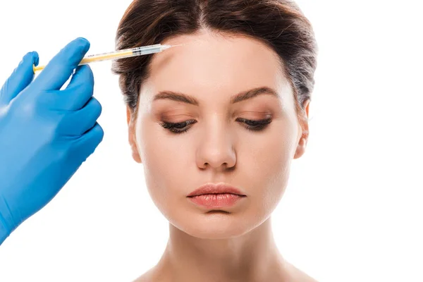 Cropped view of plastic surgeon in blue latex glove holding syringe near attractive woman isolated on white — Stock Photo