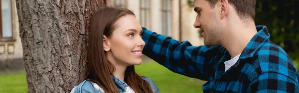 Panoramic concept of handsome student and attractive girl looking at each other — Stock Photo