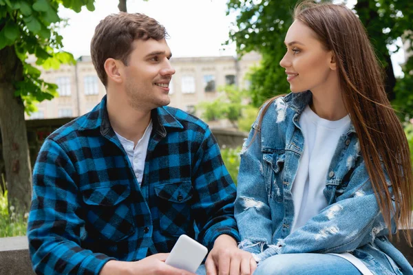 Handsome student and beautiful girl looking at each other — Stock Photo