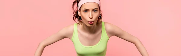 Panoramic crop of emotional sportswoman looking at camera isolated on pink — Stock Photo