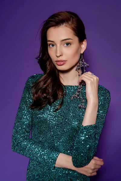 Beautiful young woman in party dress standing on purple — Stock Photo