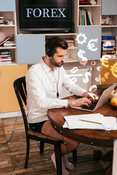 Selective focus of freelancer in shirt and panties using headset and laptop near papers on table at home, forex illustration — Stock Photo