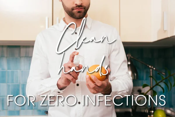 Cropped view of man disinfecting orange with hand sanitizer in kitchen, clean hands for zero infection illustration — Stock Photo