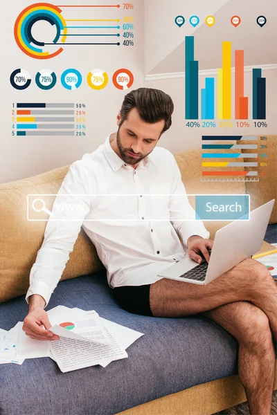 Handsome teleworker in panties and shirt working with documents and laptop on couch, charts and graphs illustration — Stock Photo