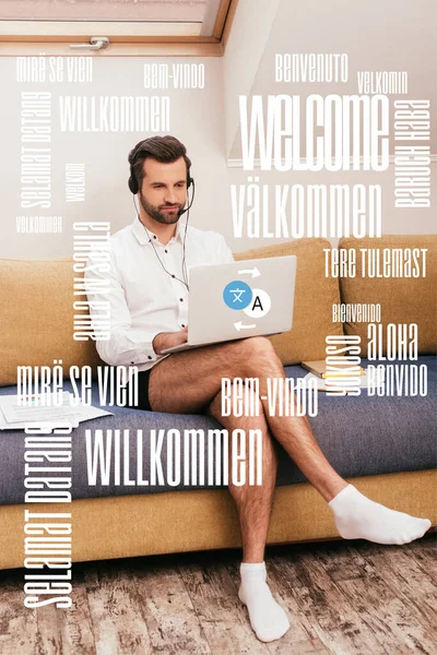 Handsome man in shirt and panties using laptop and headset on couch at home, translation illustration — Stock Photo