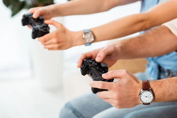 KYIV, UKRAINE - JUNE 4, 2020: Cropped view of man playing video game with girlfriend at home — Stock Photo
