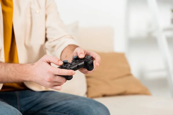 KYIV, UKRAINE - JUNE 4, 2020: Cropped view of man playing video game at home — Stock Photo