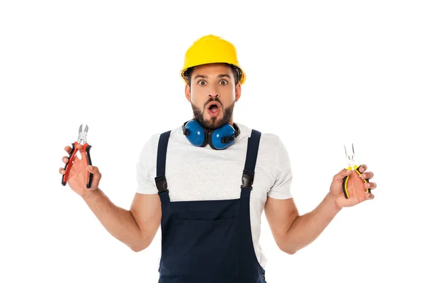 Shocked workman holding pliers and looking at camera isolated on white — Stock Photo