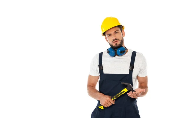 Handsome workman in uniform and hardhat holding hammer and looking at camera isolated on white — Stock Photo