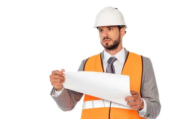 Handsome engineer in suit and hardhat holding blueprint and looking away isolated on white — Stock Photo