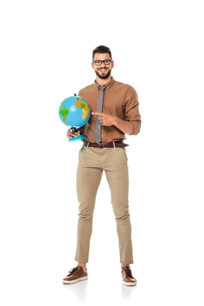 Smiling teacher pointing with finger at globe on white background — Stock Photo