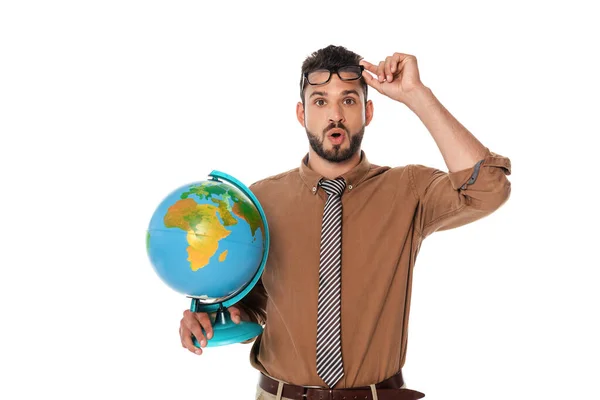 Shocked teacher holding eyeglasses and globe isolated on white — Stock Photo