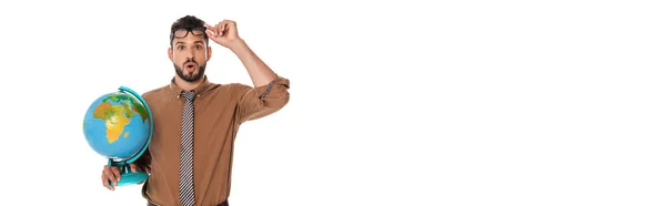 Panoramic shot of shocked teacher holding eyeglasses and globe isolated on white — Stock Photo