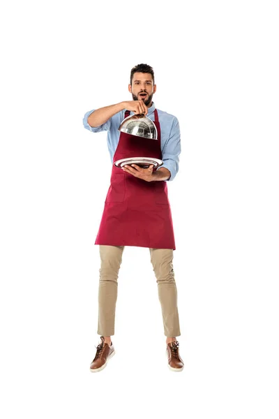 Handsome waiter holding metal tray and dish cover isolated on white — Stock Photo