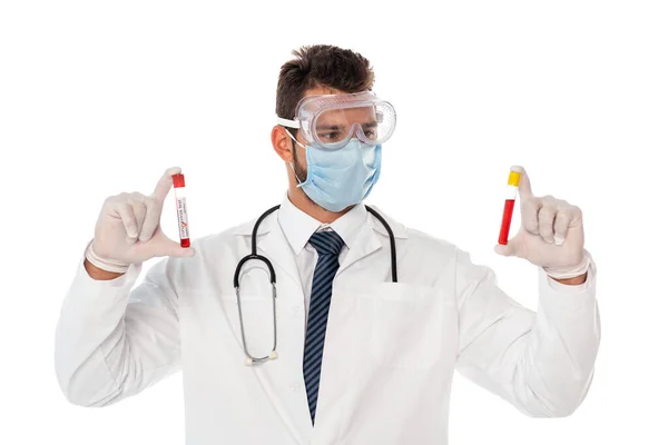 Doctor in safety mask and goggles holding test tubes of blood samples isolated on white — Stock Photo