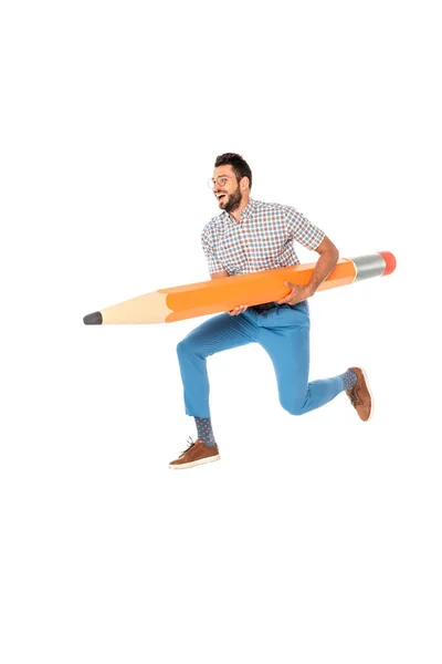 Smiling nerd holding huge pencil while jumping isolated on white — Stock Photo
