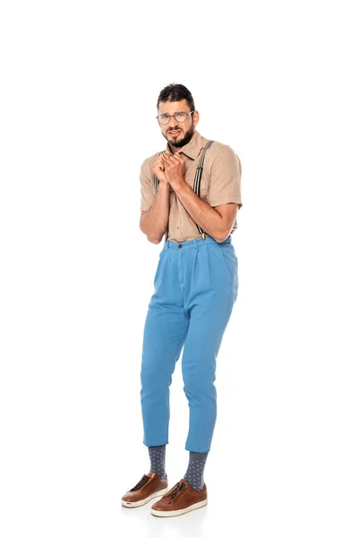 Scared nerd in suspenders looking at camera on white background — Stock Photo