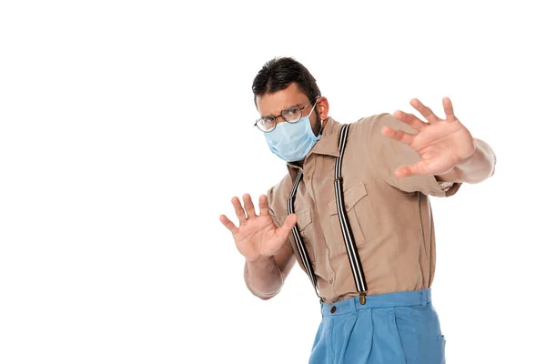 Scared nerd in medical mask showing stop gesture isolated on white — Stock Photo