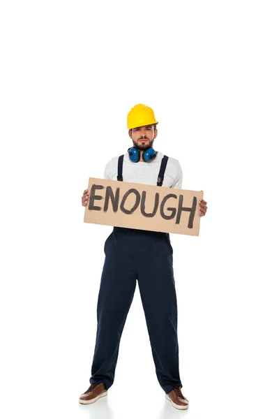 Handsome builder in uniform holding signboard with enough lettering on white background — Stock Photo