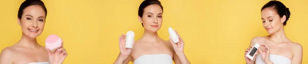 Collage of happy beautiful woman holding facial cleansing brush, hand cream and deodorants isolated on yellow, panoramic shot — Stock Photo