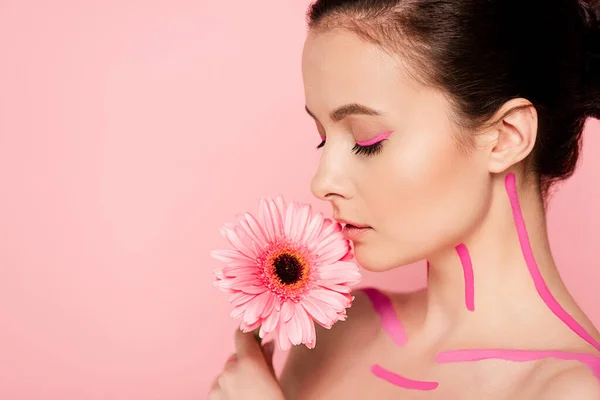 Naked beautiful woman with pink lines on body and chrysanthemum isolated on pink — Stock Photo