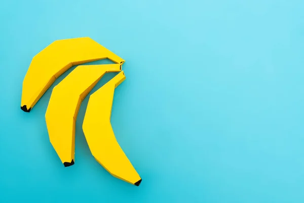 Top view of paper bananas on blue background — Stock Photo