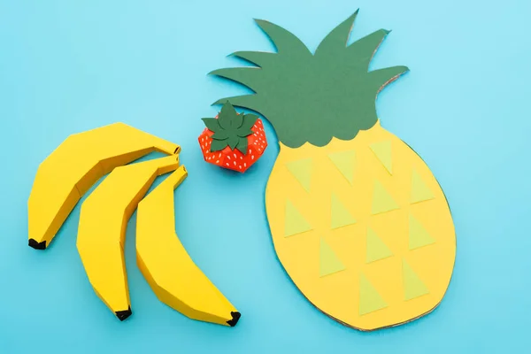 Top view of paper summer fruits on blue background — Stock Photo