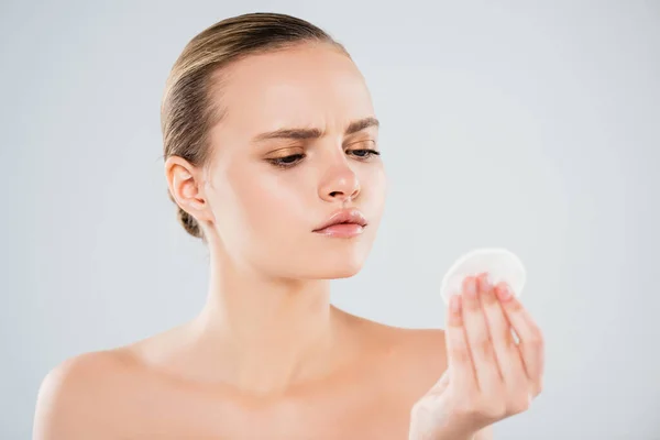 Naked young woman looking at cotton pad isolated on grey — Stock Photo