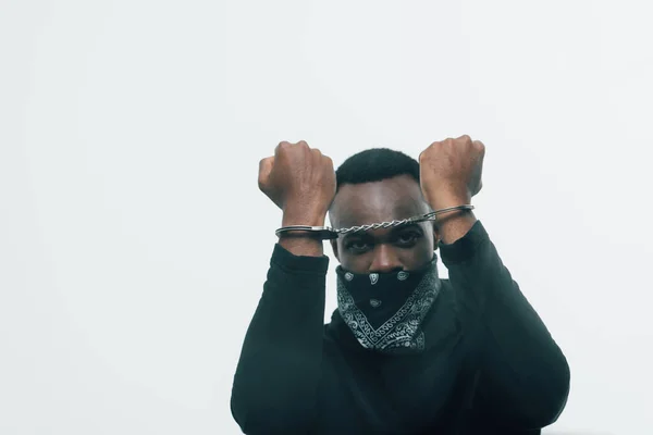 Handcuffed african american man looking at camera isolated on white, racism concept — Stock Photo