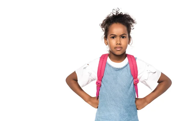 Serious african american schoolkid looking at camera while standing with hands on hips isolated on white — Stock Photo