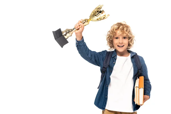 Blonder Schüler mit goldener Trophäe und Büchern auf weißem Grund — Stockfoto