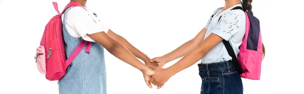 Panoramic crop of multicultural schoolchildren holding hands isolated on white — Stock Photo