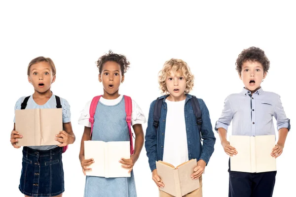 Schockierte multikulturelle Schulmädchen und Schuljungen mit Büchern auf weißem Papier — Stockfoto