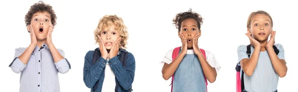 Website header of shocked multicultural schoolgirls and schoolboys touching faces while looking at camera isolated on white — Stock Photo