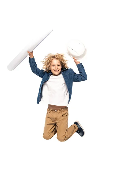 Excited boy in costume of architect holding safety helmet and blueprint while jumping isolated on white — Stock Photo