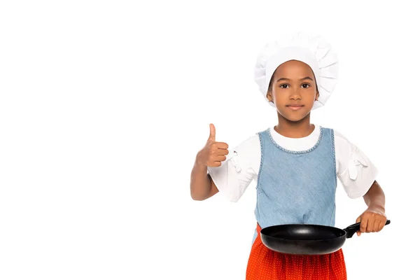 African american kid in costume of chef showing thumb up while holding frying pan isolated on white — Stock Photo