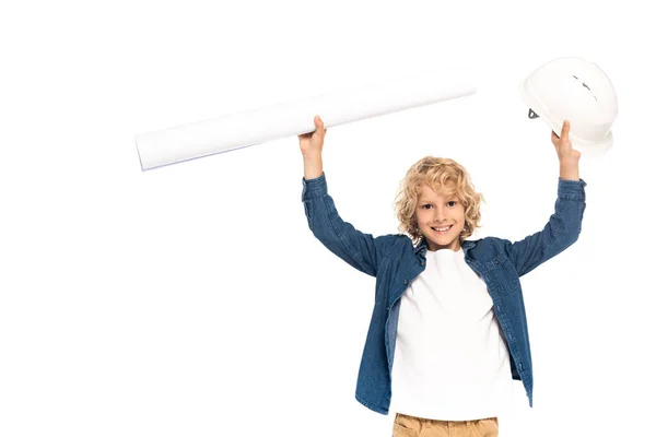 Curly boy in costume of architect holding safety helmet and blueprint above head isolated on white — Stock Photo