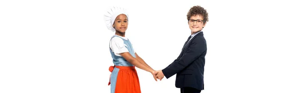 Concept panoramique de gamin et garçon afro-américain en lunettes et costume tenant les mains isolées sur blanc — Photo de stock